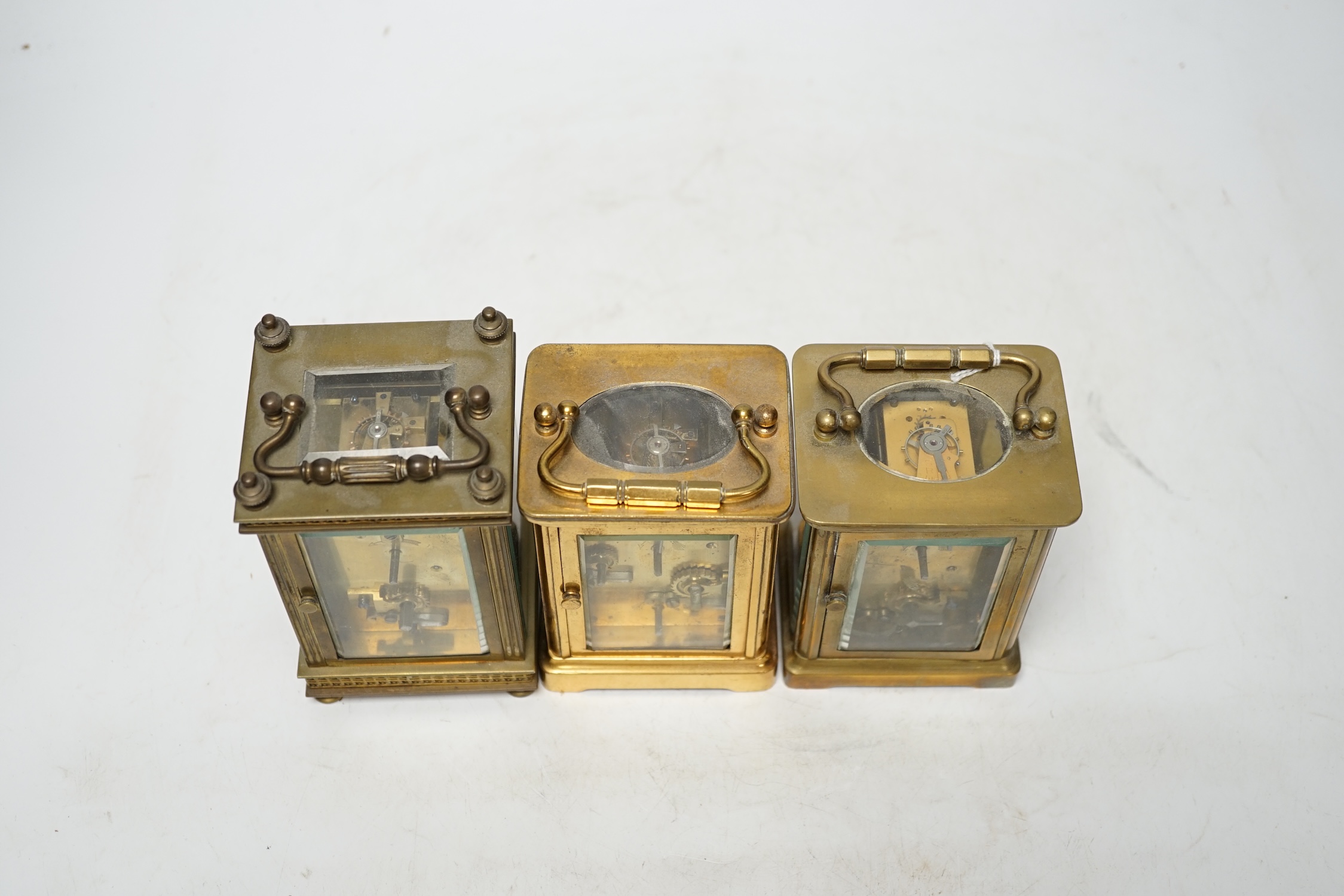 Three carriage timepieces with enamel dials, largest 14.5cm high. Condition - poor to fair